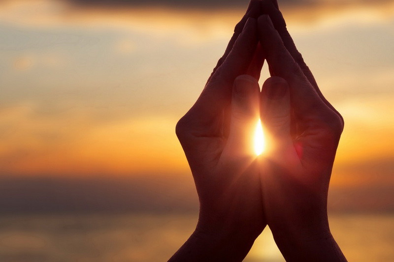 silhouette of female hands during sunset.